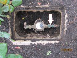 Water meter with indicator of where shut off valve is on customer side of water meter
