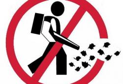 Red Circle with line over clipart of leaf blower, indicating do not blow leaves into the street